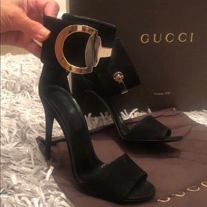 Gucci black suede heels with gold buckle.